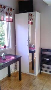 a room with a cabinet with a table and a mirror at Pärlebo in Mellbystrand