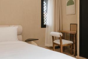 a bedroom with a bed and a desk and a chair at Marrakech Villa with Private Pool & Family-Friendly in Marrakesh
