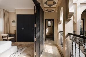 a hallway of a home with a black door at Marrakech Villa with Private Pool & Family-Friendly in Marrakesh