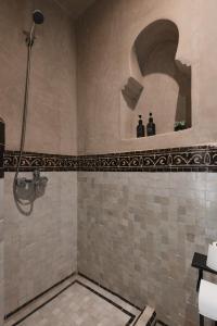 a bathroom with a shower with a tiled floor at Marrakech Villa with Private Pool & Family-Friendly in Marrakesh