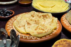 a plate of pancakes on a table with other foods at Marrakech Villa with Private Pool & Family-Friendly in Marrakesh