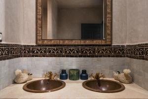 a bathroom with two sinks and a mirror at Marrakech Villa with Private Pool & Family-Friendly in Marrakesh