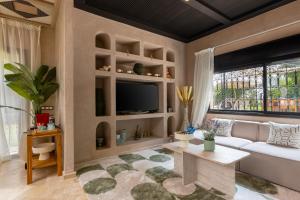 a living room with a couch and a tv at Marrakech Villa with Private Pool & Family-Friendly in Marrakesh +37 photos