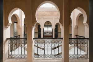 a view from the courtyard of a building with arches at Marrakech Villa with Private Pool & Family-Friendly in Marrakesh