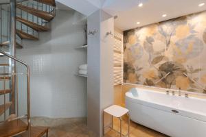 a bathroom with a bath tub and a staircase at GARDEN VILLA SUITE - Hotel Villa Schuler in Taormina