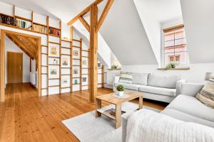 a living room with a white couch and a table at Apartmán Karlstadt in Karlovy Vary