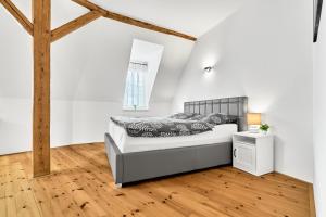 a bedroom with a bed and a wooden floor at Apartmán Karlstadt in Karlovy Vary