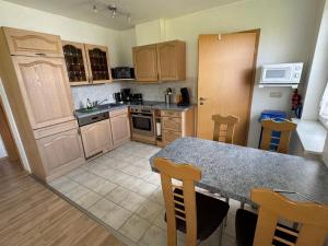 a kitchen with a table and chairs and a counter top at Ferienwohnung auf zwei Ebenen mit Terrasse in Gägelow