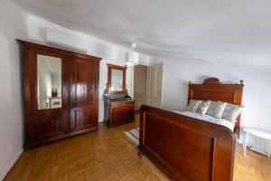 a bedroom with a bed and a dresser in it at Casa Tradizionale Volosko in Opatija