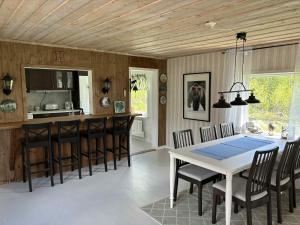 a kitchen and dining room with a table and chairs at Sjöstugan in Hudiksvall