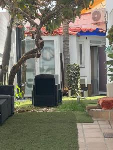 a television sitting on the grass in front of a house at Mex-Goretti House in Mairena del Aljarafe