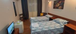 Postel nebo postele na pokoji v ubytování Matev Hotel