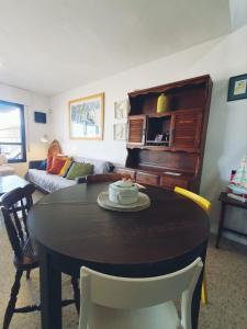 a living room with a table and a couch at alquilaencanarias El Medano Spectacular terrace and sea views A in El Médano +11 photos