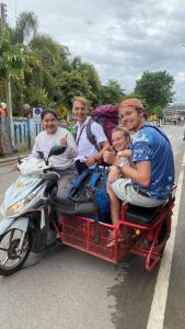 a group of people riding on the back of a motorcycle at Hug Pai Boutique hostel in Pai