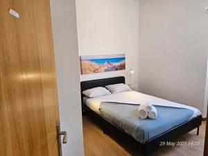 a bedroom with a bed with two towels on it at Blife Bandaya private rooms at Faro beach in FAO