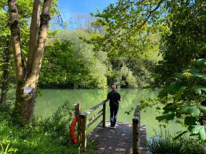 a man walking on a bridge over a lake at Sunridge Geodome with private Hot tub in Plymouth +90 photos