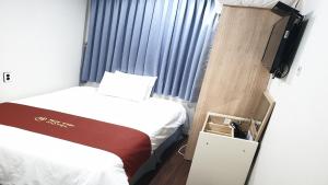 Postel nebo postele na pokoji v ubytování MAYONE HOTEL Myeongdong