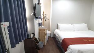 Postel nebo postele na pokoji v ubytování MAYONE HOTEL Myeongdong