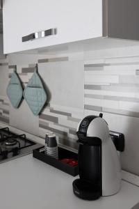 a coffee maker sitting on a counter in a kitchen at Terrazza Domese in Domodossola +18 photos