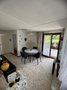 a living room with a table and chairs at Romantic bungalow in Balatonudvari