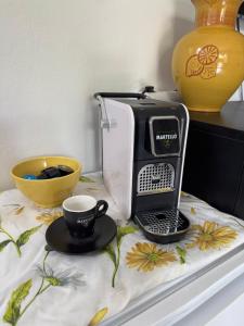 a coffee maker and a cup on a table at Romantic bungalow in Balatonudvari