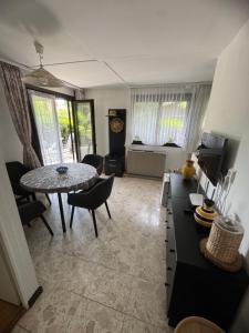 a living room with a table and a dining room at Romantic bungalow in Balatonudvari +7 photos