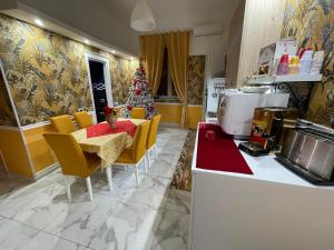 a kitchen with a christmas tree and a table and chairs at Cappuccini Sweet Home in Pozzuoli