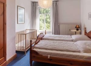 a bedroom with two beds and a window at Ferienwohnung Alter Dorfkrug 4 in Kronsgaard