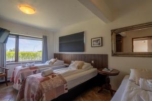 En eller flere senger på et rom på Hotel Skógá by EJ Hotels