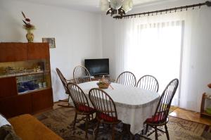 a dining room with a table and chairs at Apartment Anton in Pinezici +17 photos