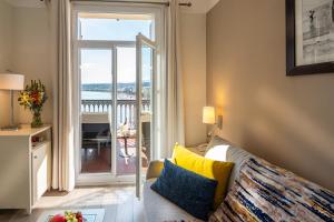 a living room with a couch and a large window at Hotel Suisse in Nice
