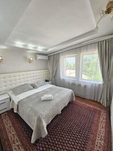 a bedroom with a large bed and a window at Bella Donna Hotel in Chişinău