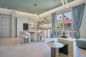 a kitchen and living room with a table and chairs at Bougainvillea Bliss in Skala Kefalonias