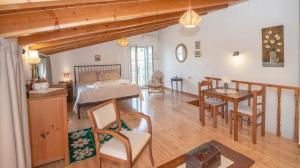 a living room with a bed and a dining room at Liopetra at Messaria Corfu! in Mesariá