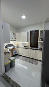a large kitchen with white cabinets and a large appliance at Villa Franca on sea in Mazara del Vallo