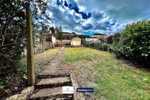 a yard with a fence and a sign in the grass at The Jungle Comfy & Spacious 3BR by AltoLuxo Short Lets & Serviced Accommodation With Free WiFi & Parking in Bristol