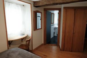 a bedroom with a bed and a bathroom with a sink at Hosteria de Zubiri in Zubiri