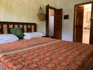 a bedroom with a large bed in a room at Shantam Homestay - Peace has an address now! in Cheruthuruthi