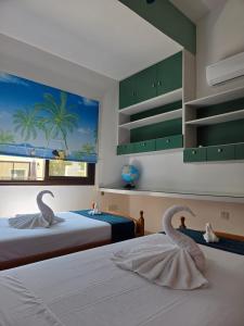 two swans sitting on two beds in a bedroom at Marinea 2 in Paphos +54 photos