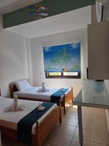 a hotel room with two beds and a view of the ocean at Marinea 2 in Paphos City