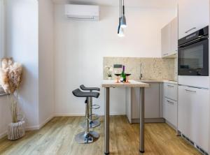 a kitchen with a small table and a stool at B&B apartment 2 in Rijeka