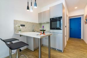 a kitchen with white cabinets and a counter top at B&B apartment 2 in Rijeka