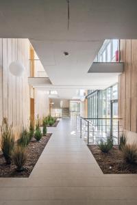 an empty hallway in a building with plants at Sea Whisper apartamentai Daukanto g Palanga in Palanga
