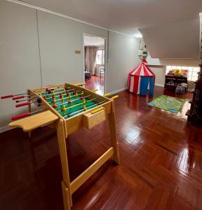 a living room with a table with a foos ball at Urban Grace in Bangkok