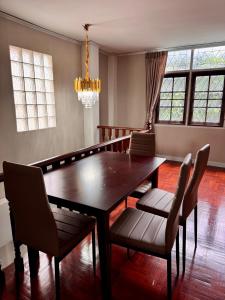 a dining room with a wooden table and chairs at Urban Grace in Bangkok +16 photos