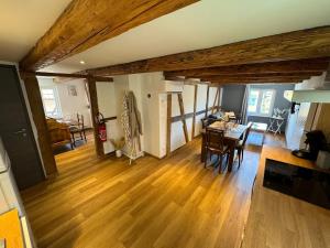 a living room with a table and a dining room at Maison Alsacienne Centre Alsace in Hilsenheim