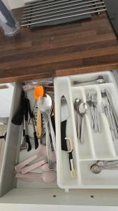 a drawer filled with utensils in a kitchen at BougainvillaStudio in Cesme +18 photos