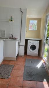 a kitchen with a washing machine and a sink at Comfortable room 1 in Bristol