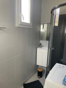 a bathroom with a shower and a sink and a mirror at Sion sur locean - trois chambres in Saint-Hilaire-de-Riez