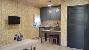 a kitchen with a table and a tv on a wall at Stepanavan Forest House in Stepʼanavan